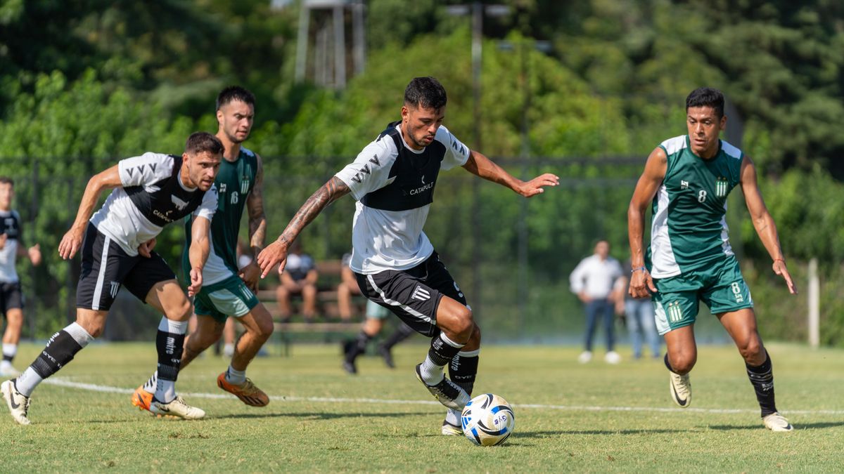 Soccer players in action on a vibrant outdoor field during a sunny day.
