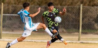 Two soccer players in action during a competitive outdoor match.