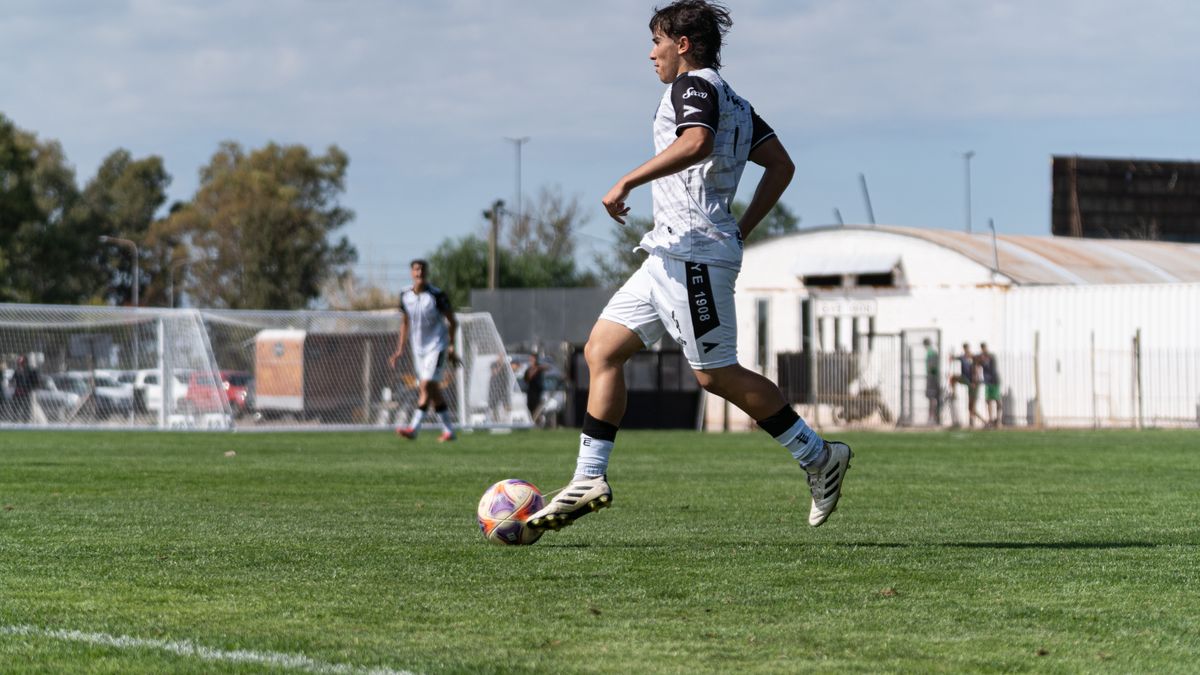 A soccer player in motion on the field, demonstrating skill and focus during a match.