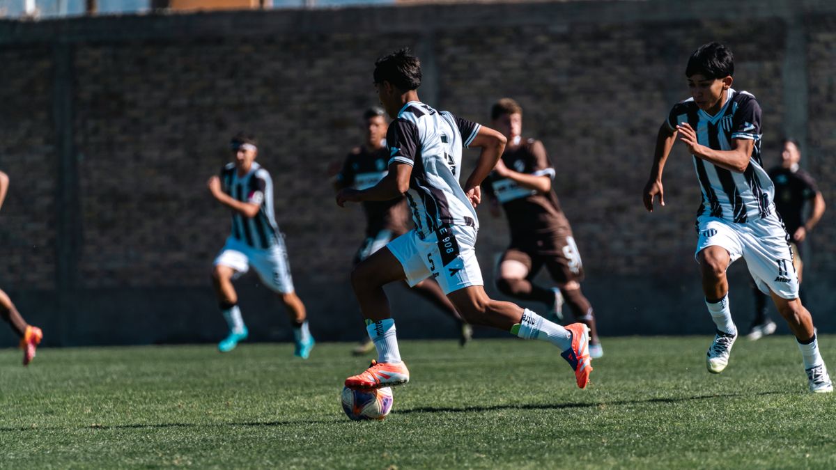 Athletes in action during an outdoor soccer match, daytime.