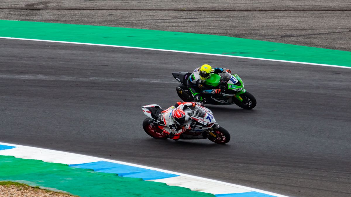 Motorcyclists racing on a track during a thrilling motorsport event in Portugal.
