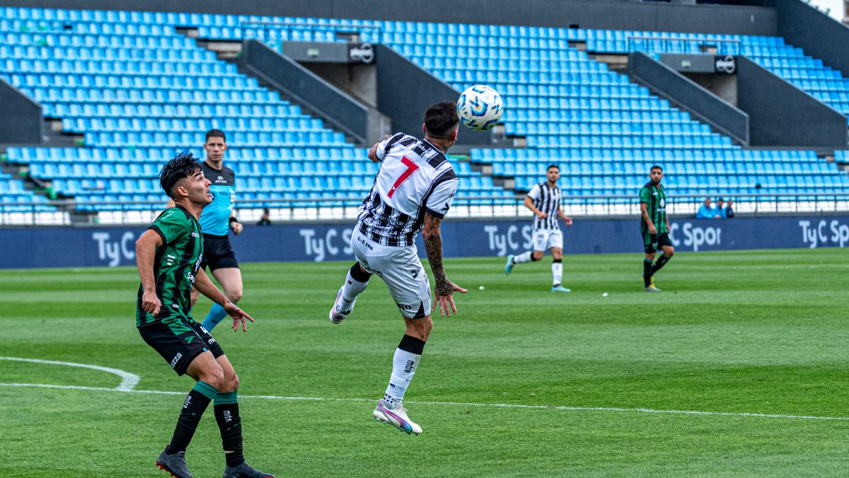 Action-packed soccer match with players competing in a vibrant stadium.