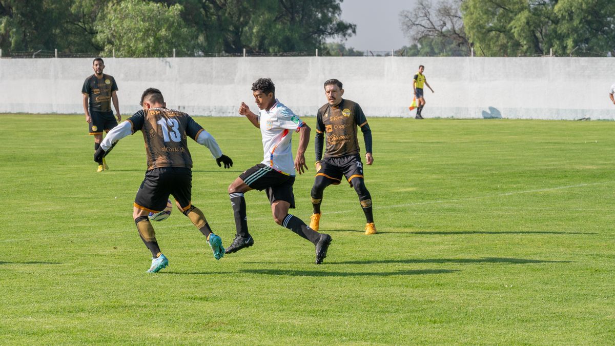 Athletes engaged in a competitive soccer match outdoors, showcasing teamwork and sportsmanship.