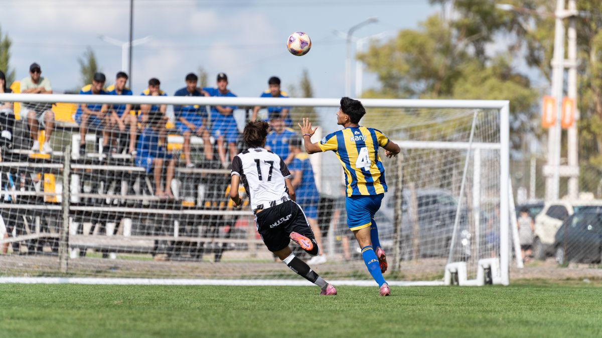 Dynamic capture of a youth soccer match with players competing fiercely near the goal. Dynamic capture of a youth soccer match with players competing fiercely near the goal.