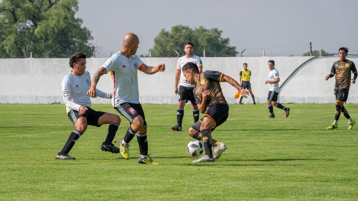 Dynamic soccer match featuring players in motion on a sunny outdoor field.