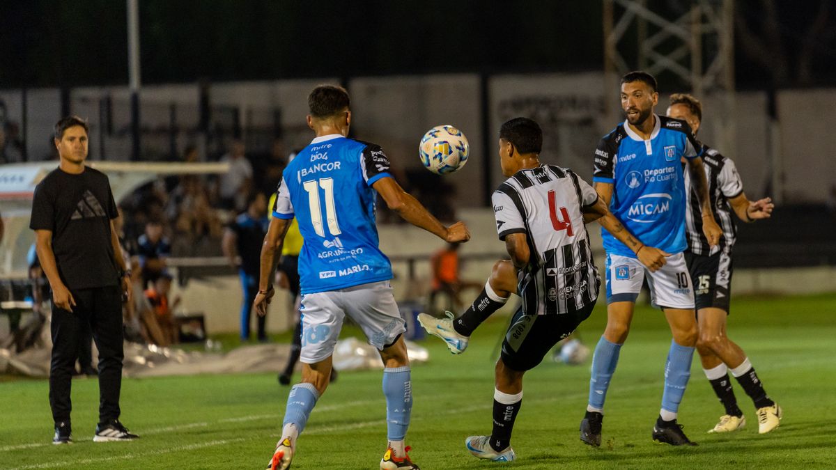 High-energy soccer match under stadium lights showcasing player dynamics and sports energy.
