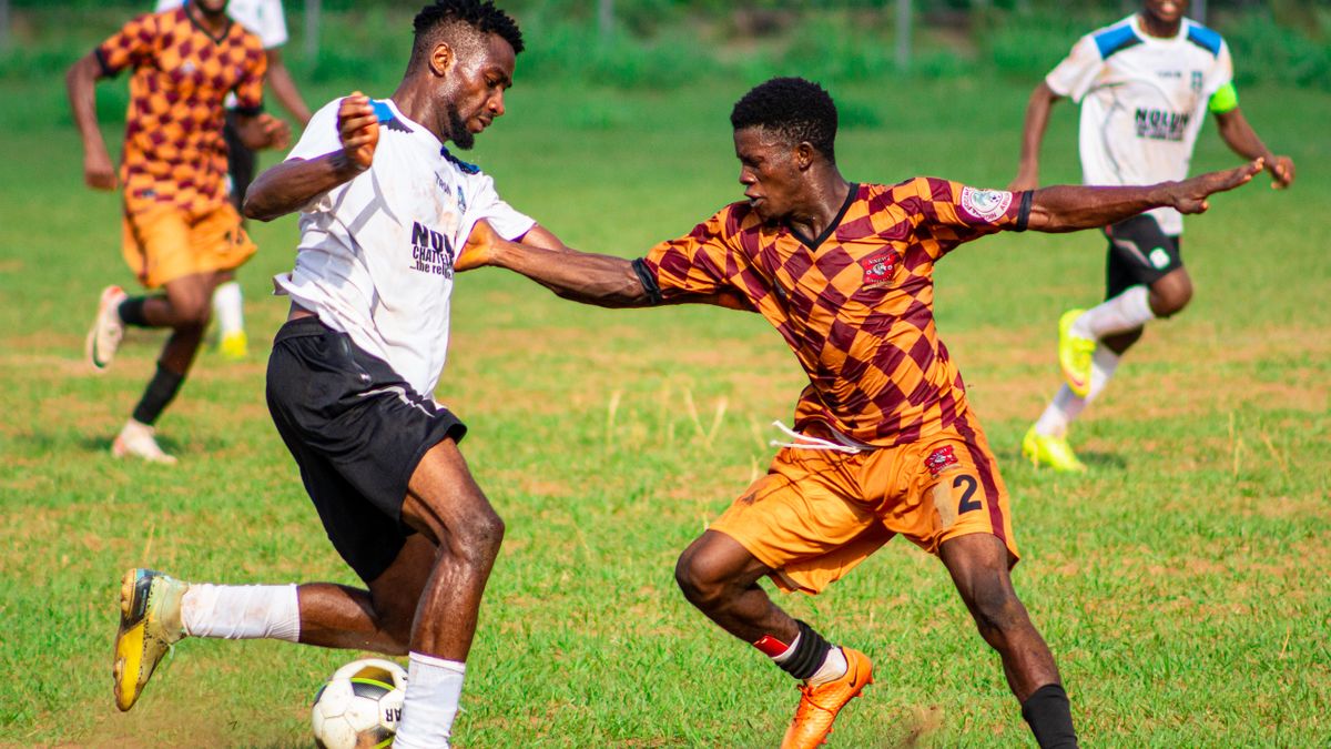 Players in action during a competitive soccer match outdoors.