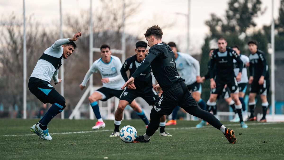 Dynamic soccer game with players in action on a grassy field, showcasing athletic skill.