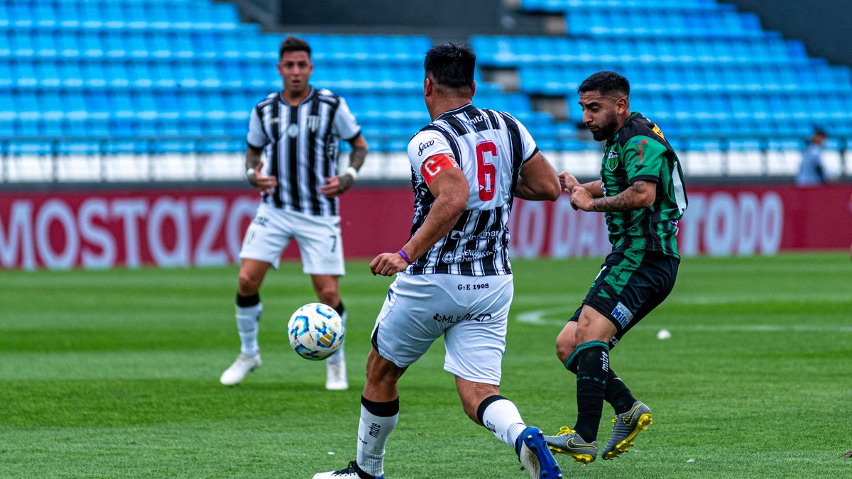 Dynamic soccer match scene with players competing for the ball on a professional field.