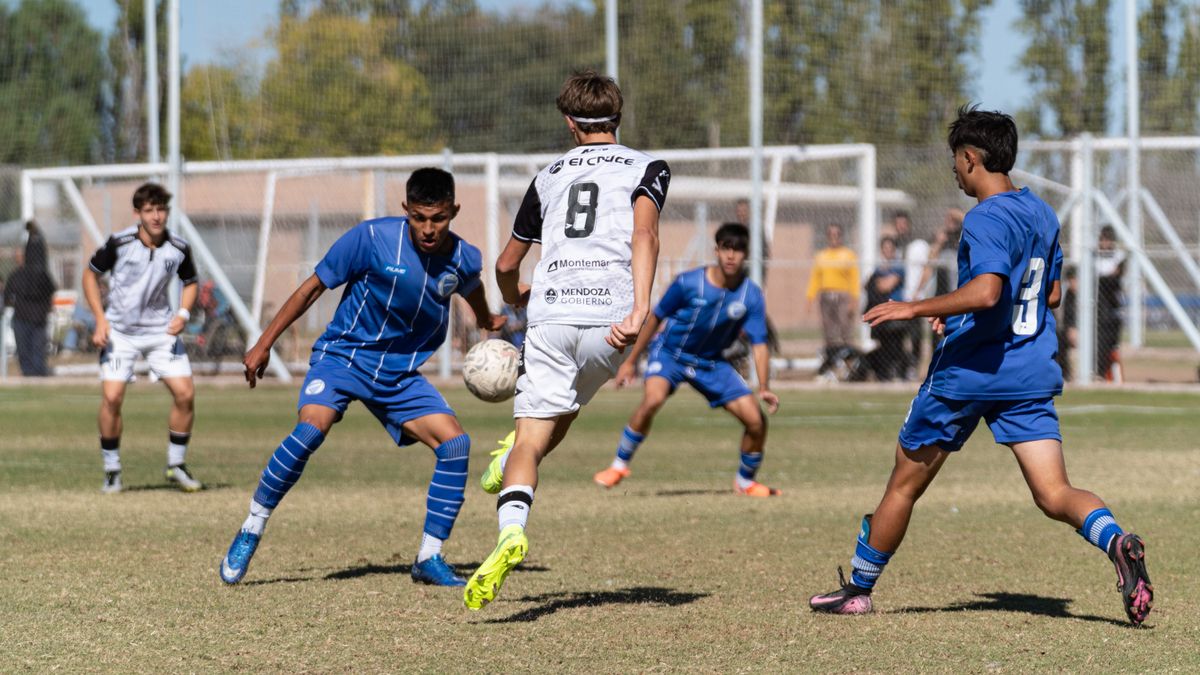 Dynamic scene of teenage soccer players competing on a sunny day. Dynamic scene of teenage soccer players competing on a sunny day.