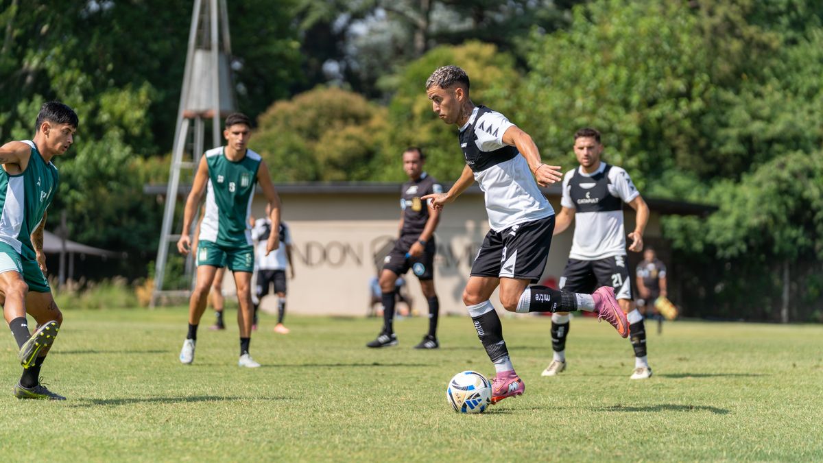 Dynamic view of a soccer game with male players in action during a sunny day outdoors. Dynamic view of a soccer game with male players in action during a sunny day outdoors.