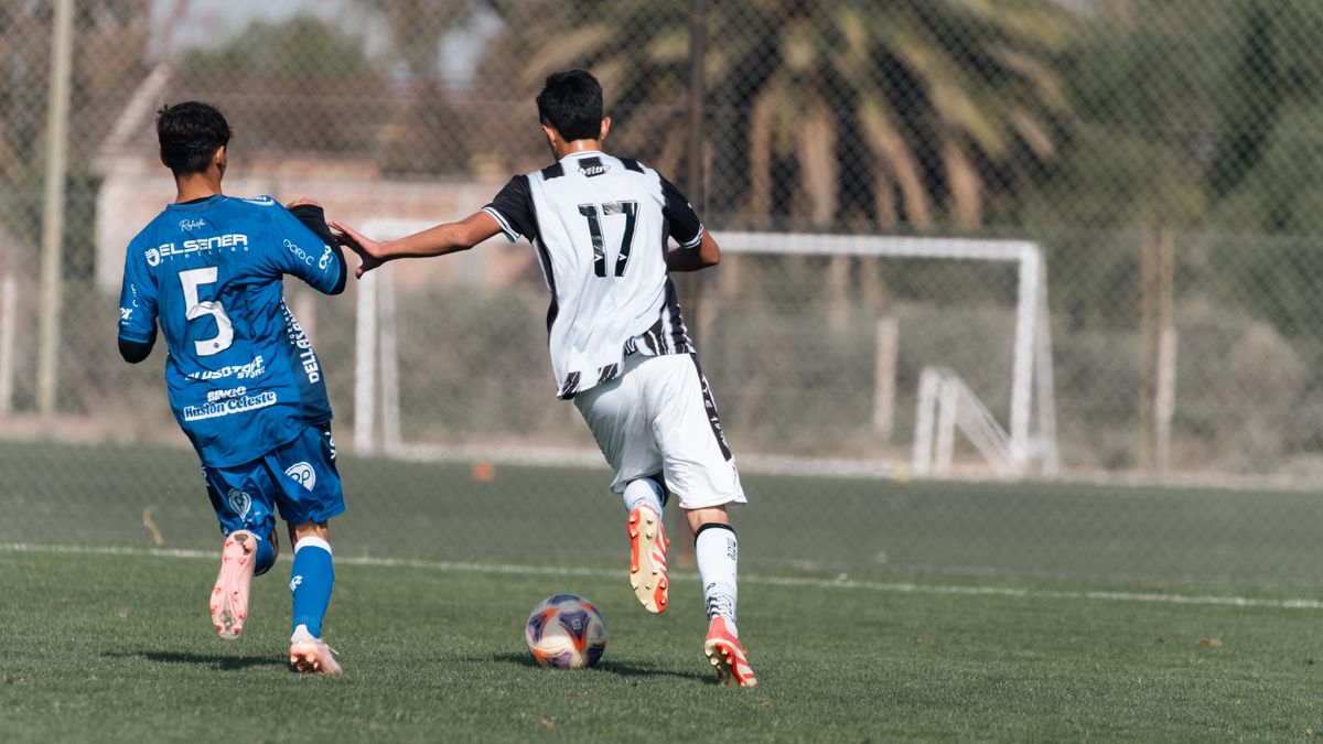 Exciting moment captured during a soccer match with two players running for the ball. Exciting moment captured during a soccer match with two players running for the ball.