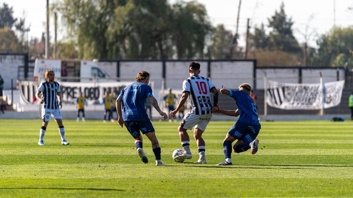 Players engaged in a competitive soccer match on a bright sunny day. Players engaged in a competitive soccer match on a bright sunny day.