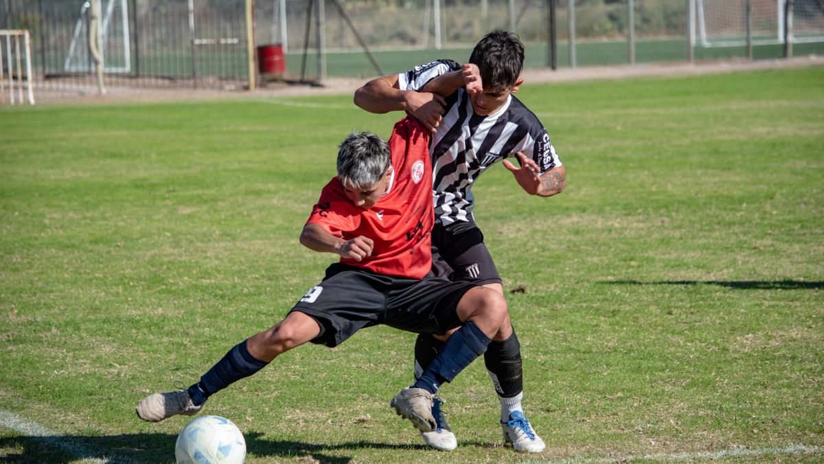 Two male soccer players in action on the field during a match.