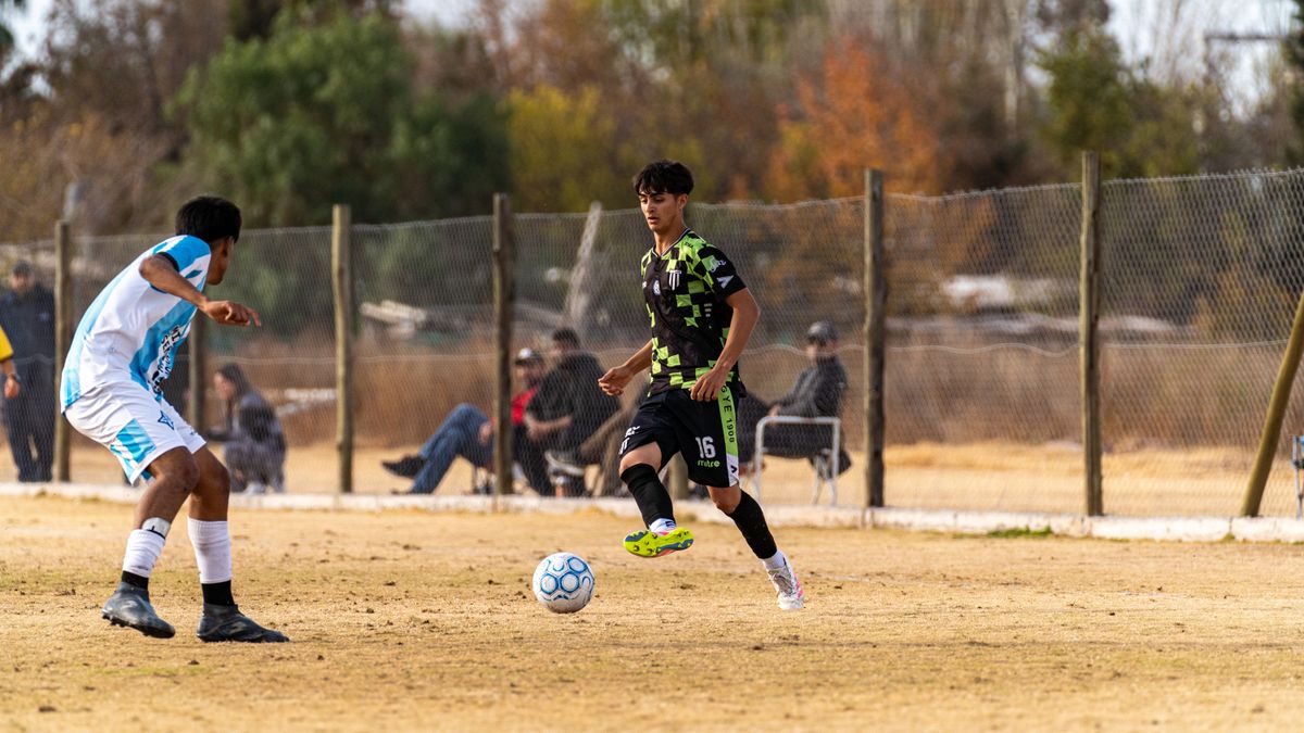 Young soccer players in action on a sunny day. Energetic outdoor sports scene.