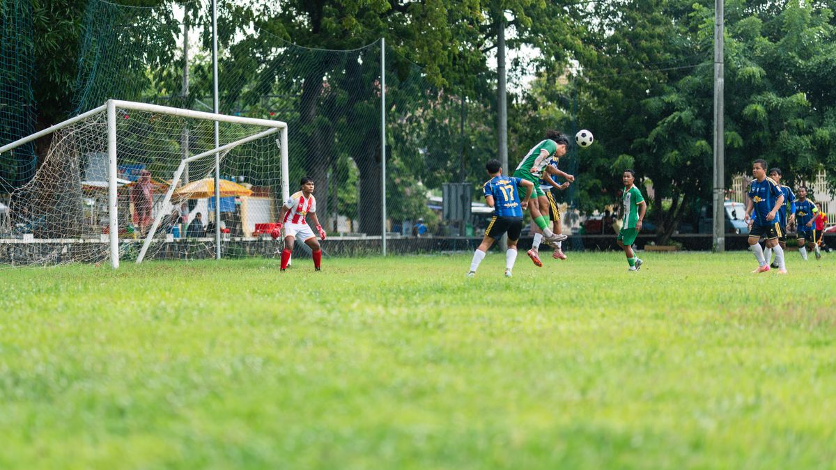 Youth soccer players in action during a match on a sunny day, showcasing agility and teamwork.