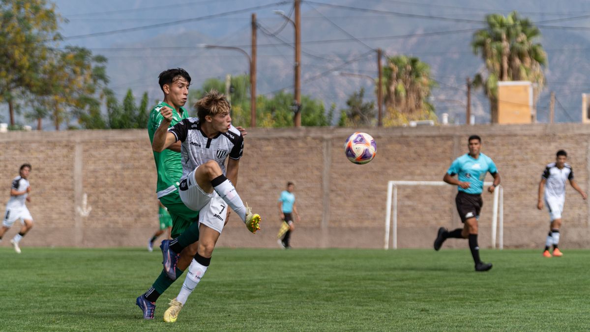 Dynamic soccer match scene with players competing actively on a grassy field.