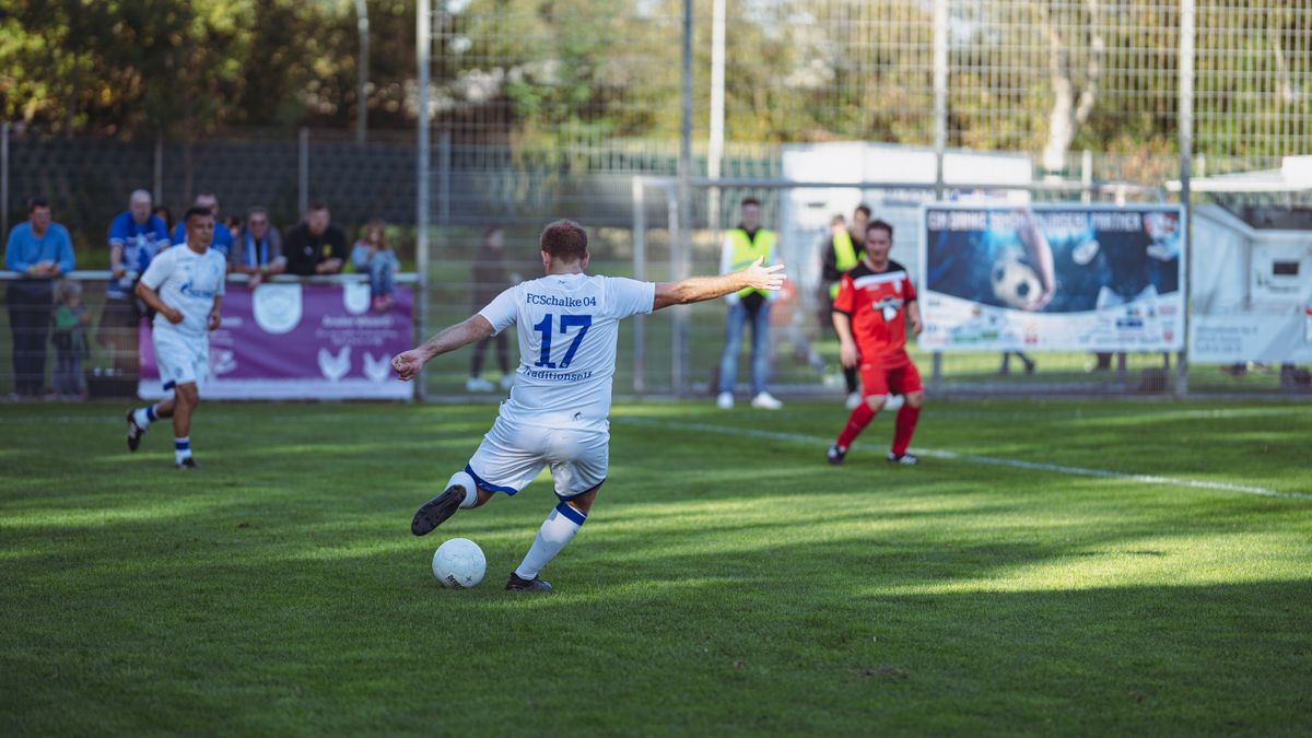 Action-packed soccer game with players in motion on a sunlit field, showcasing competitive spirit.
