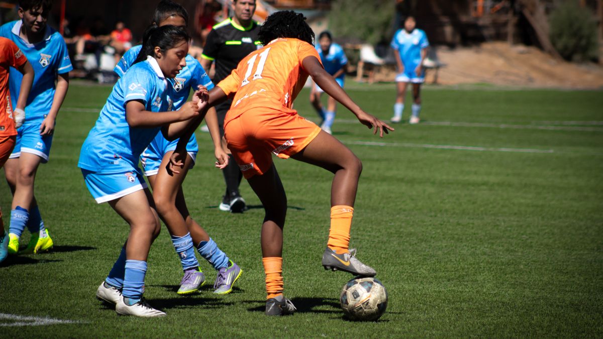 Action shot of a women's soccer match highlighting teamwork and competition. Action shot of a women's soccer match highlighting teamwork and competition.