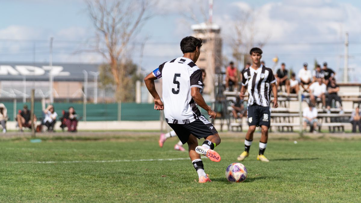 Action shot of young soccer players in a competitive match outdoors. Action shot of young soccer players in a competitive match outdoors.