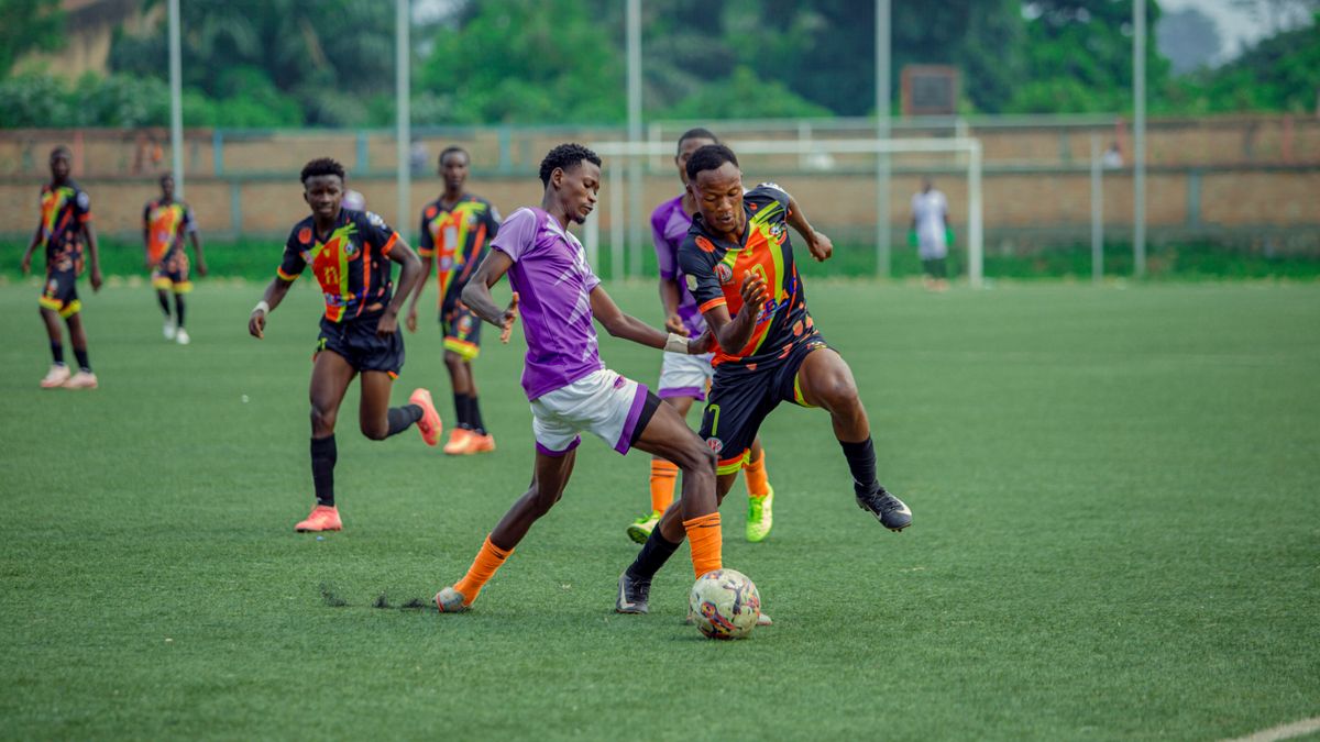 Dynamic action shot of young soccer players competing on an outdoor field.
