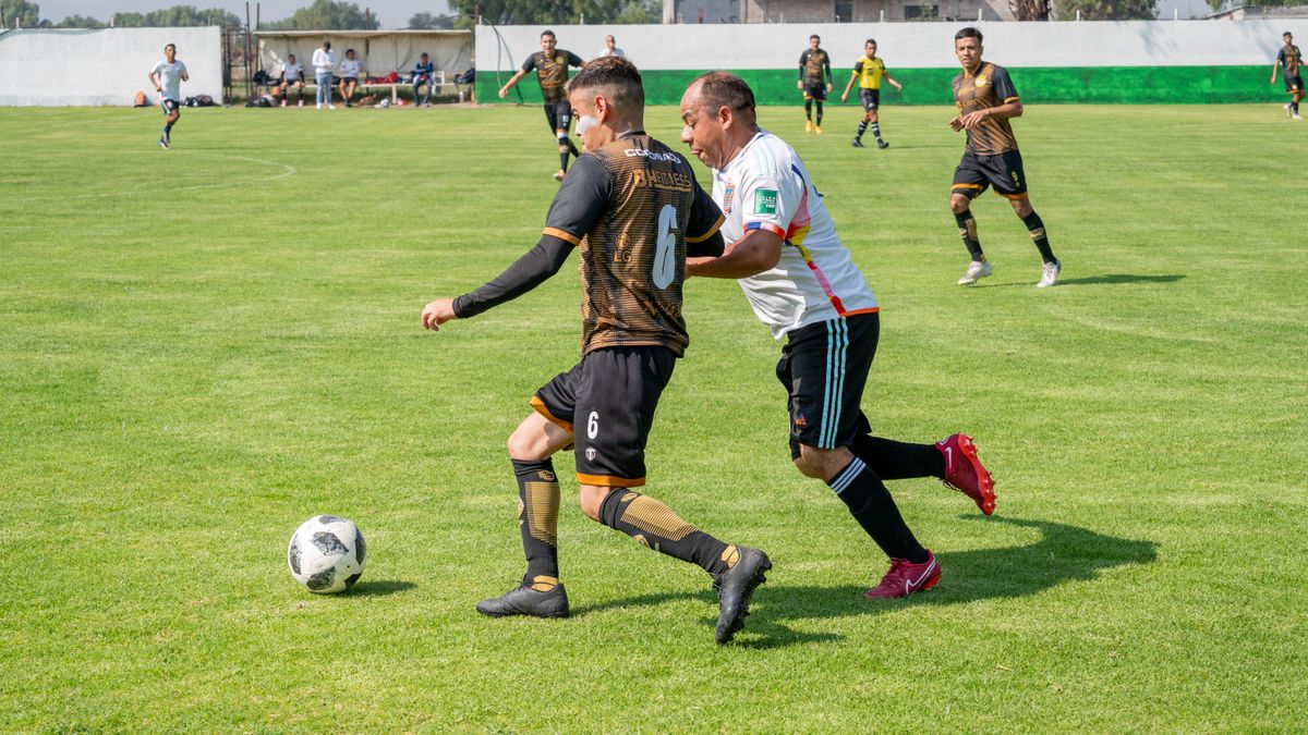 Players in action during a competitive soccer game on a green field, showcasing intense athletic performance.