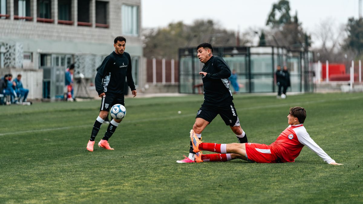 Players in action during an intense soccer match outdoors, showcasing teamwork and competition. Players in action during an intense soccer match outdoors, showcasing teamwork and competition.