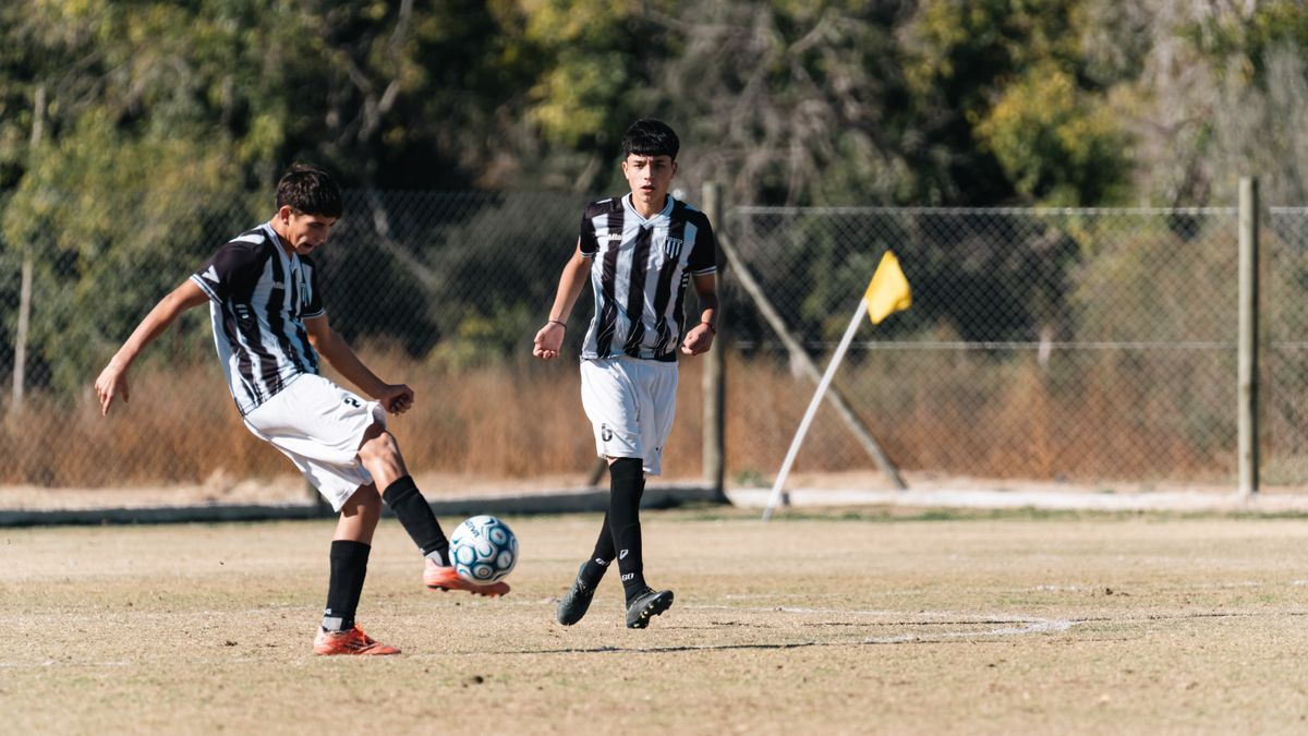 Two teenage players in action on an outdoor soccer field, sunny day. Two teenage players in action on an outdoor soccer field, sunny day.