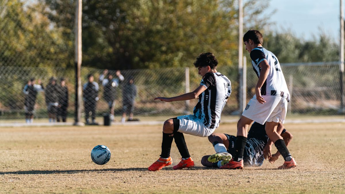 Energetic youth soccer match showcasing a dynamic play moment on a sunny day.