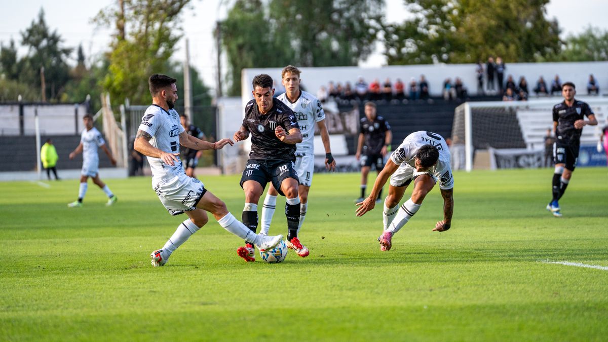 Exciting action shot of a soccer match with players competing intensely on the green field.