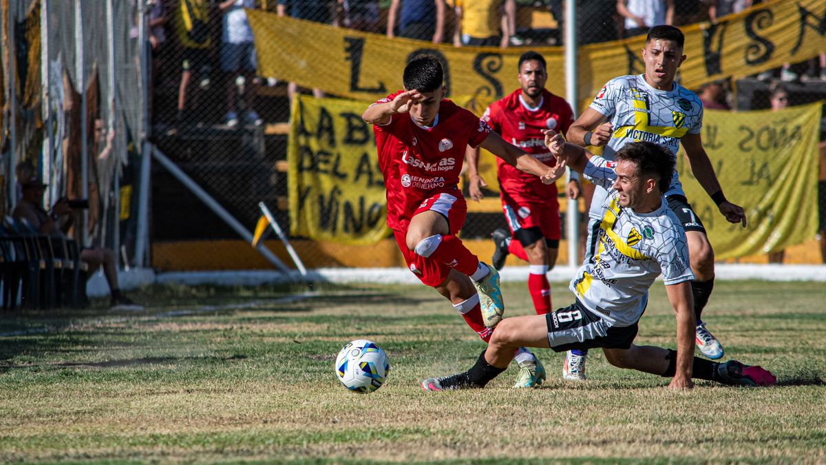 Exciting moment from a soccer match with players in action on a sunny day.