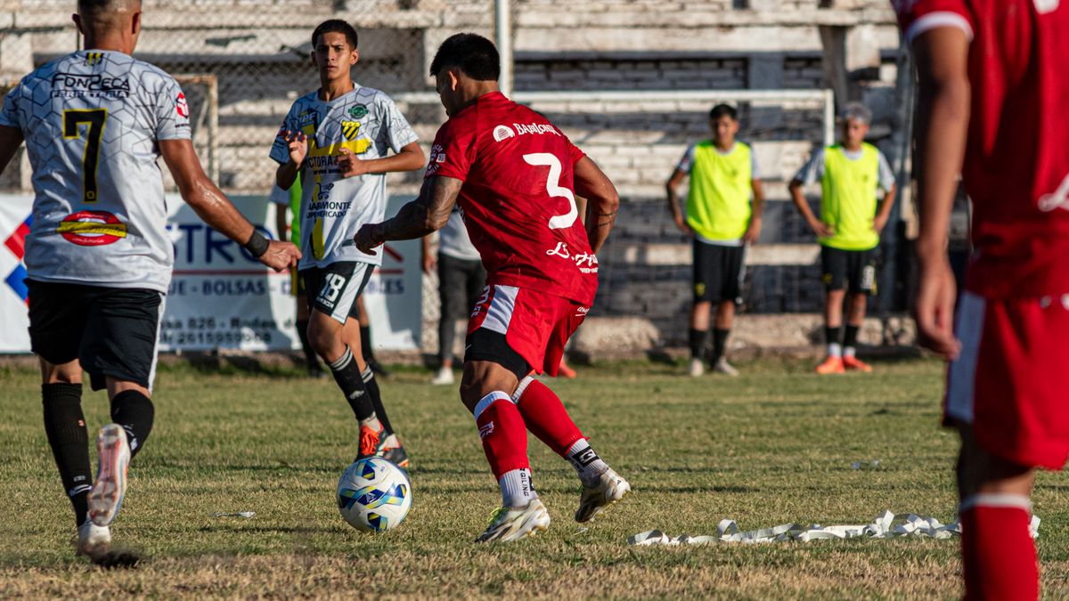Intense soccer match with players in action on outdoor field, showcasing teamwork and sportsmanship.