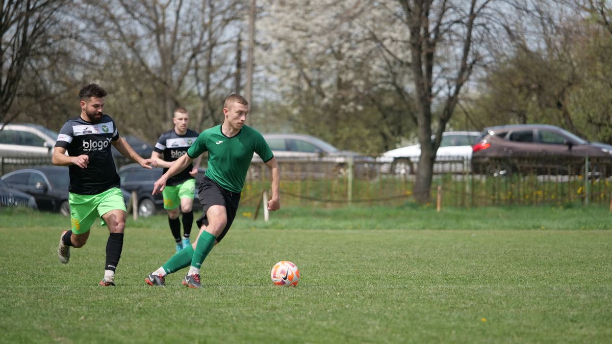 Action shot of an amateur soccer match in a park, showcasing teamwork and skill. Action shot of an amateur soccer match in a park, showcasing teamwork and skill.