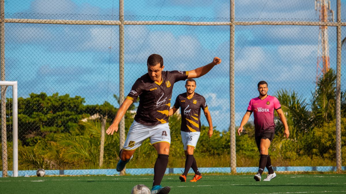 Athletes playing soccer in an outdoor field showcasing teamwork and agility. Athletes playing soccer in an outdoor field showcasing teamwork and agility.