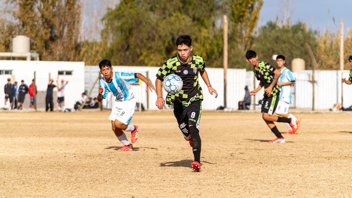 Dynamic action shot of teenagers playing soccer on a sunny field. Dynamic action shot of teenagers playing soccer on a sunny field.