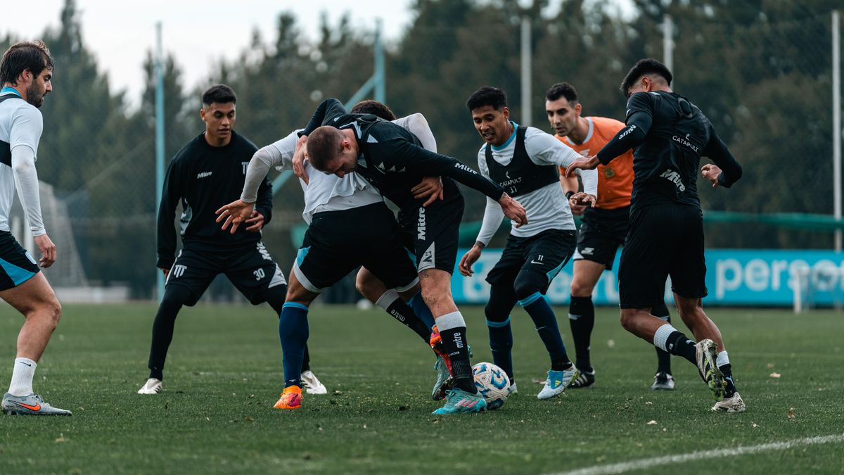 Intense soccer practice with team players competing for the ball on a green field. Intense soccer practice with team players competing for the ball on a green field.