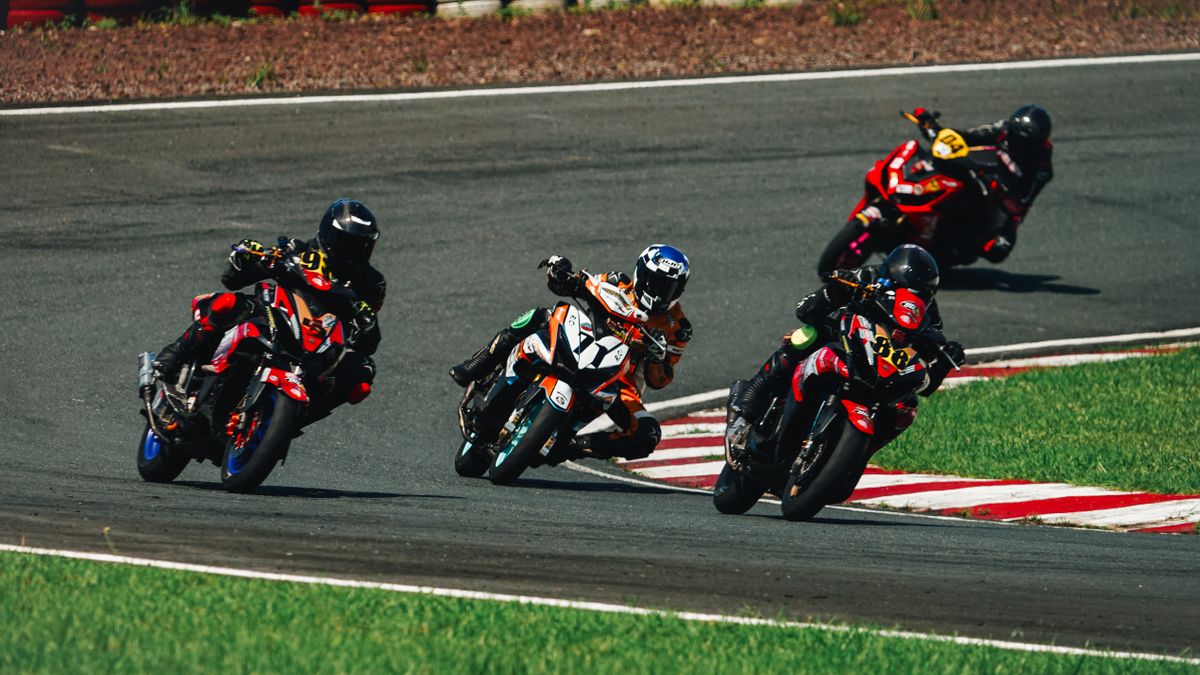 Motorcyclists competing in a thrilling race at Rosario track, Philippines. Motorcyclists competing in a thrilling race at Rosario track, Philippines.