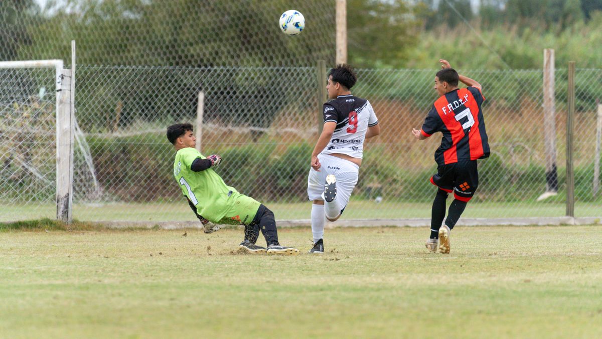 Three soccer players in action on a grass field during an outdoor game. Three soccer players in action on a grass field during an outdoor game.