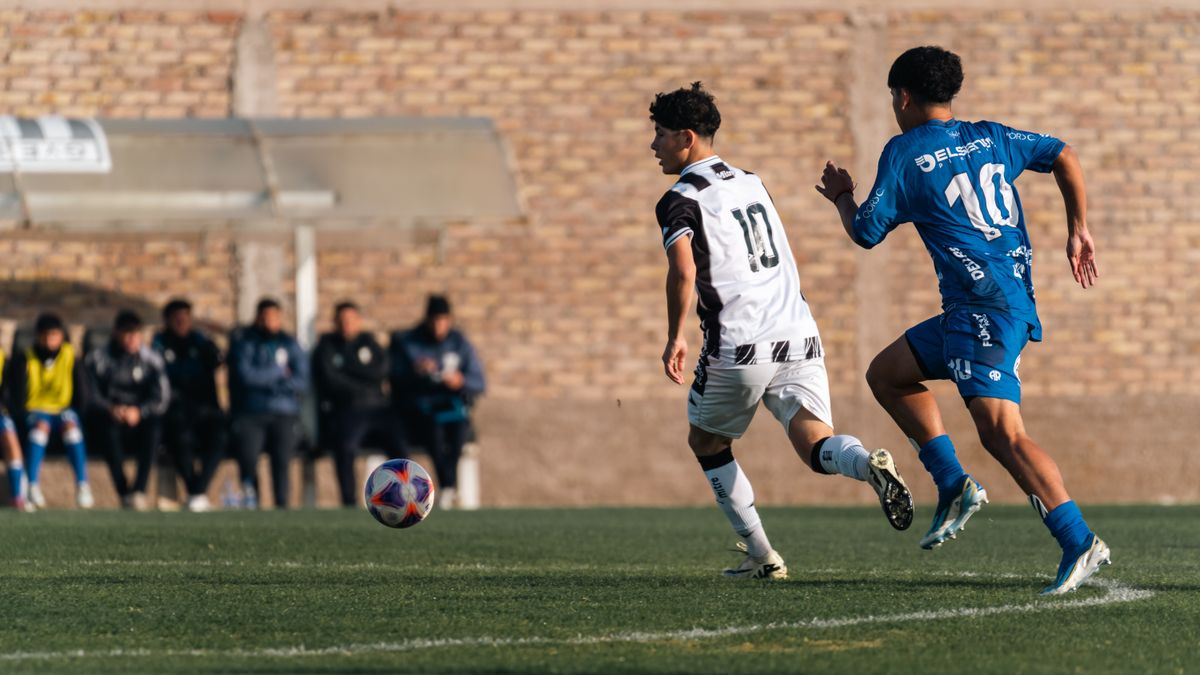 Two soccer players competing intensely on the field, showcasing sportsmanship and agility.
