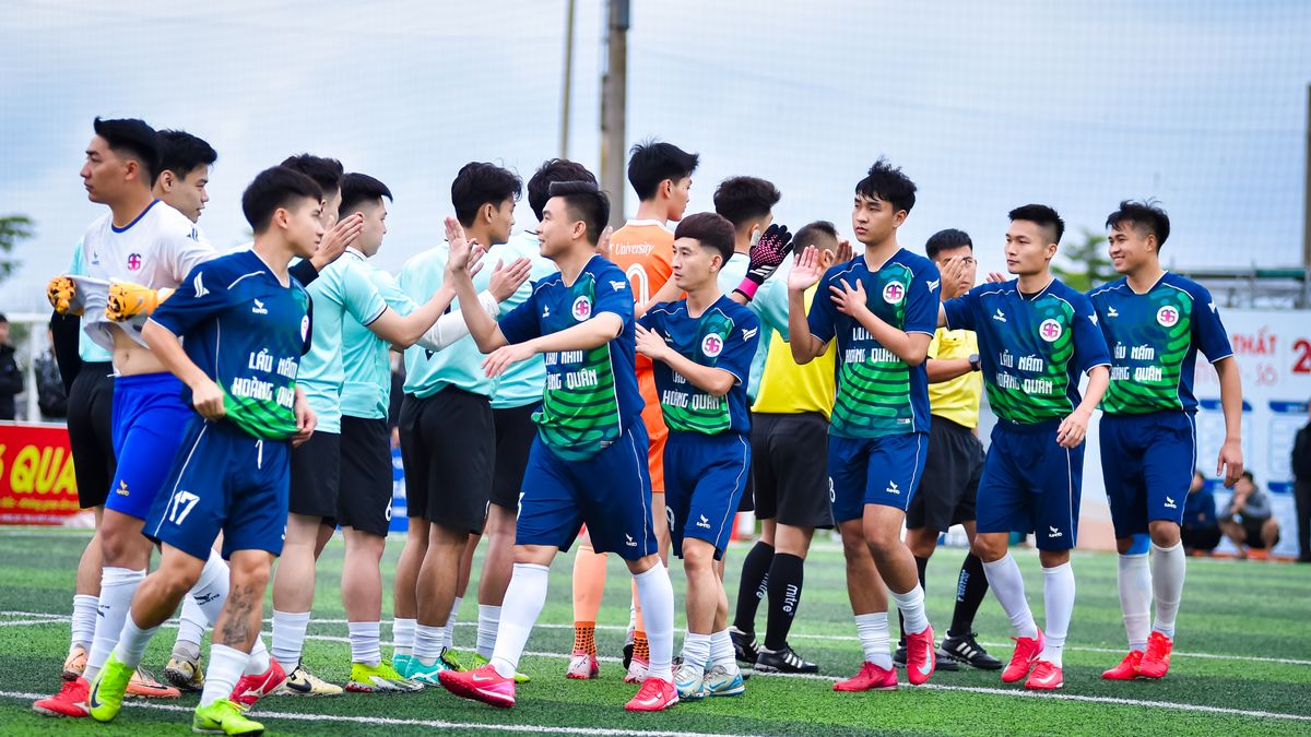 Two soccer teams shaking hands before a match in Hanoi, Vietnam.