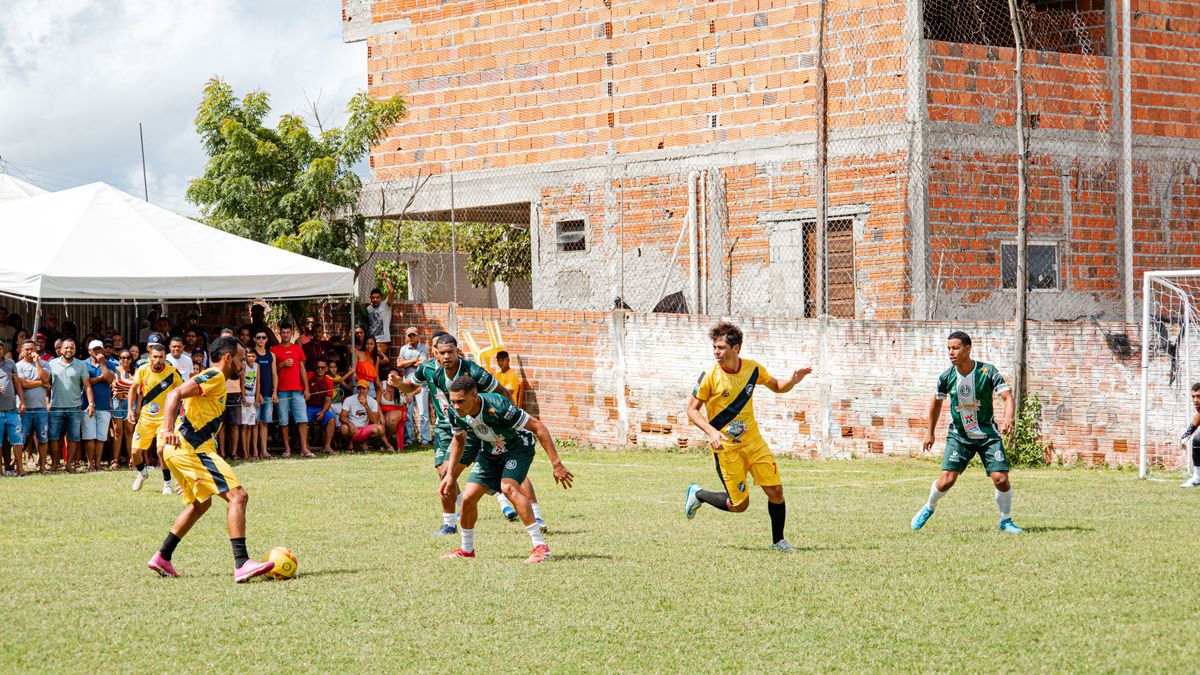 Amateur soccer game with enthusiastic crowd in urban setting, showcasing lively competition.