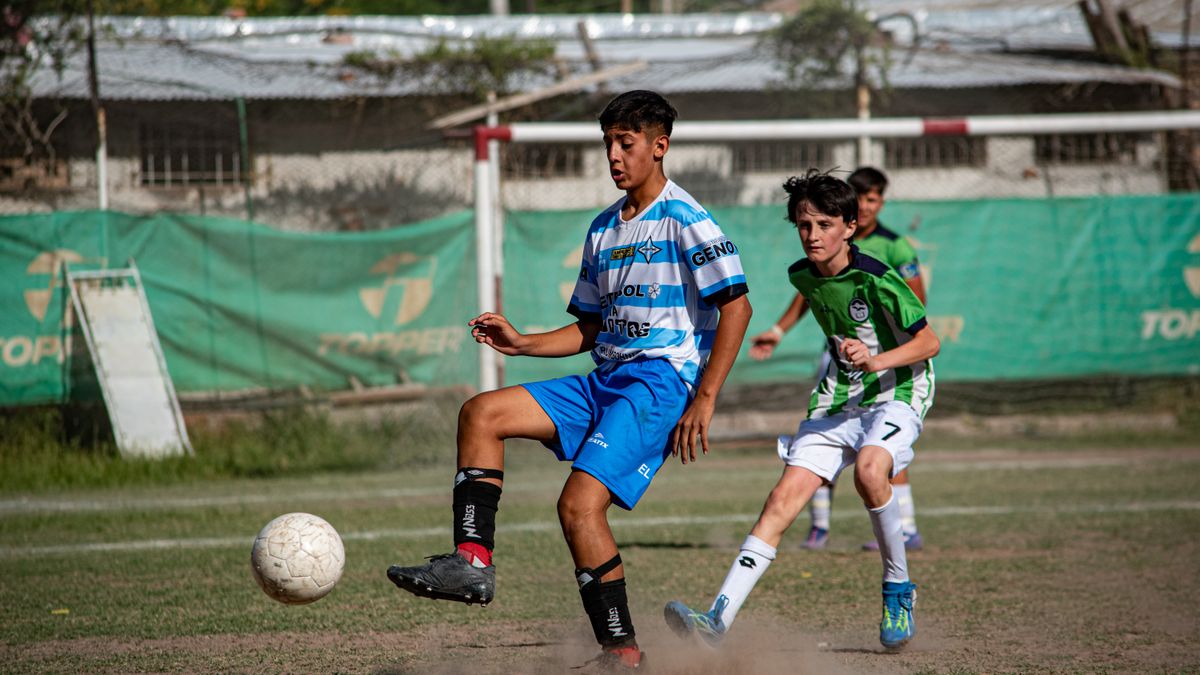 Boys playing soccer in an outdoor field, showcasing team spirit and competition. Boys playing soccer in an outdoor field, showcasing team spirit and competition.