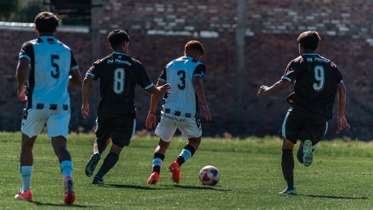 Exciting action shot of young athletes competing in a soccer match on a grassy field. Exciting action shot of young athletes competing in a soccer match on a grassy field.