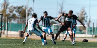 Intense outdoor soccer match showcasing players in motion on the field.