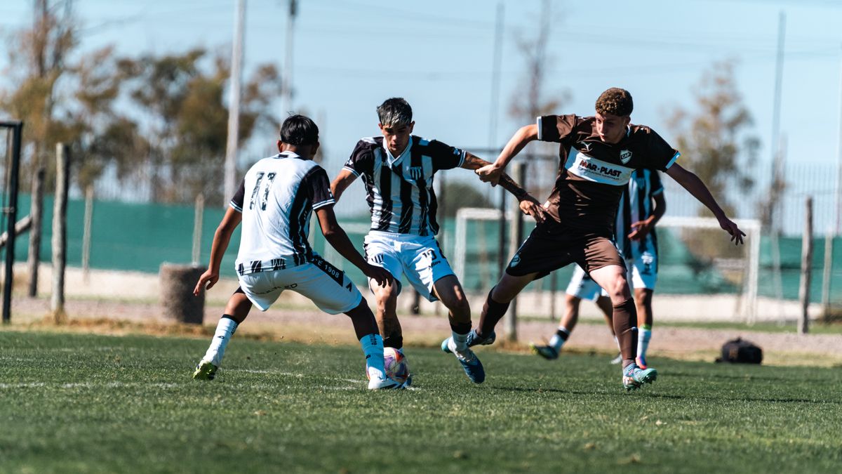 Intense outdoor soccer match showcasing players in motion on the field. Intense outdoor soccer match showcasing players in motion on the field.