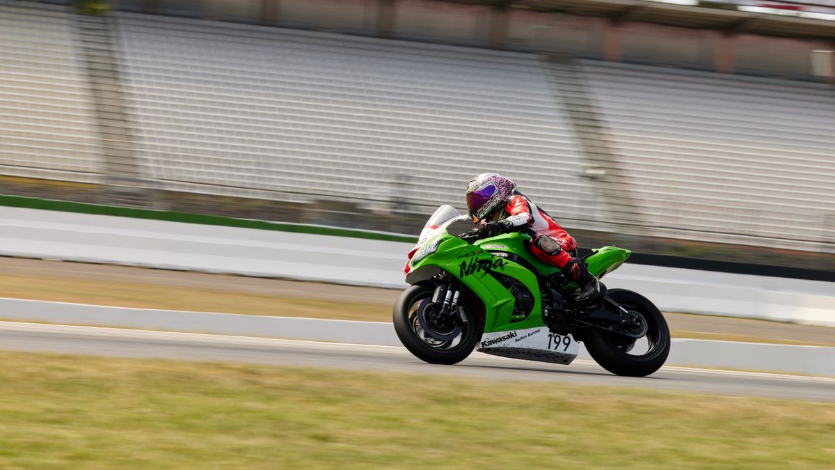 Professional motorcycle racer speeding at Hockenheimring in Germany. High-speed sports action captured outdoors. Professional motorcycle racer speeding at Hockenheimring in Germany. High-speed sports action captured outdoors.