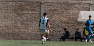A team of young soccer players competing on an outdoor field, showcasing sportsmanship.