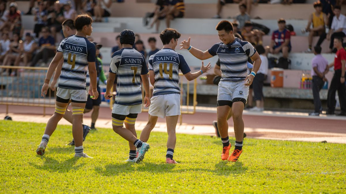 Teen rugby players celebrating a victory on a sunny day with enthusiastic teamwork. Teen rugby players celebrating a victory on a sunny day with enthusiastic teamwork.