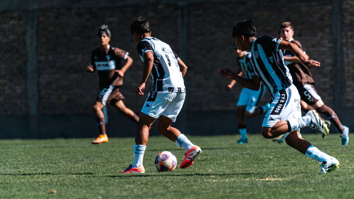 Teenage boys play competitive soccer on a sunny day, showcasing teamwork and agility. Teenage boys play competitive soccer on a sunny day, showcasing teamwork and agility.