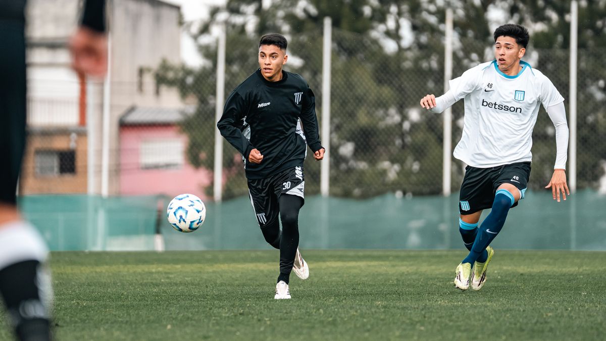 Two young soccer players competing fiercely on a grassy field during an outdoor match. Two young soccer players competing fiercely on a grassy field during an outdoor match.